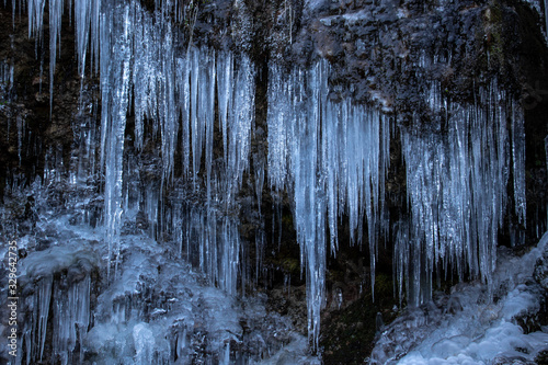 Obraz na plátne Many icicle on a rock, Bohinj valley
