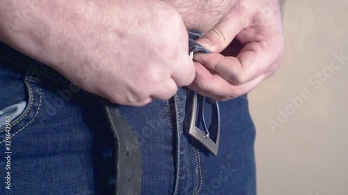 the man who unfastens his jeans photo