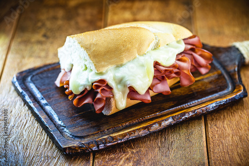 mortadella sandwich, made with a great Italian mortadella sausage, a sandwich popular in Brazil, especially in São Paulo. The sandwich is made with half a pound of sausage and cheese. photo