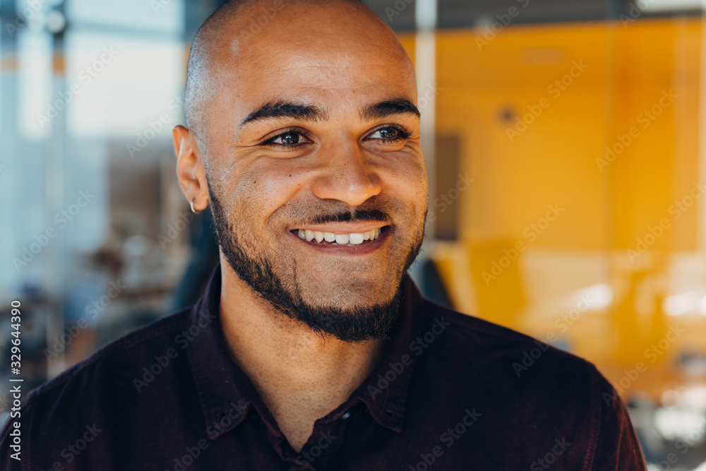 Happy african american businessman entrepreneur startup owner stand in modern office looking at camera, smiling young black designer creative person posing in work space Happy african american businessman entrepreneur startup owner stand in modern office looking at camera, smiling young black designer creative person posing in work space