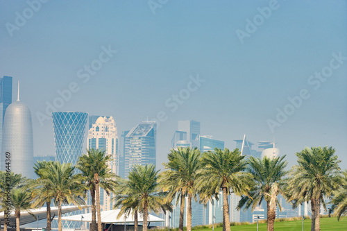 Panoramic view of modern skyline of Doha with Palms foreground. Concept of healthy environment © Hladchenko Viktor
