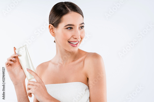 Beauty concept. Attractive young woman with perfect skin holding cosmetic tube