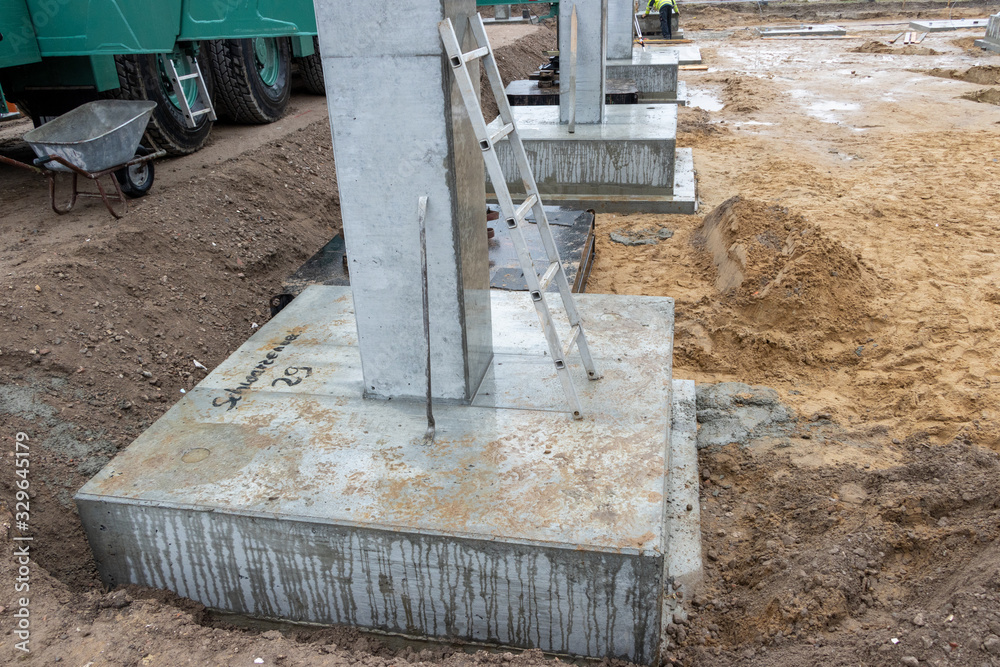 some Concrete columns for a factory building are erected on a large construction site some Concrete columns for a factory building are erected on a large construction site