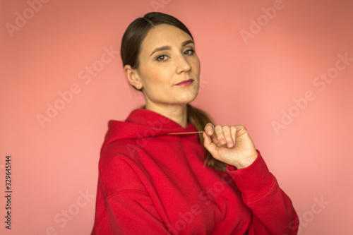 young woman in a bright red hoodie