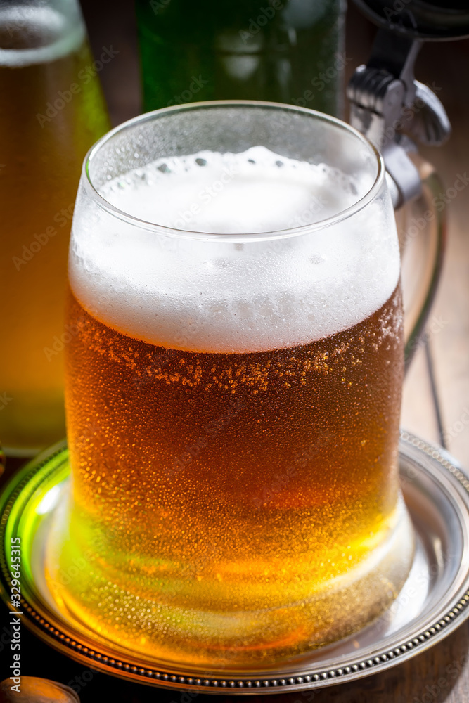 Light beer in a glass on a table in composition with accessories on an old background Light beer in a glass on a table in composition with accessories on an old background