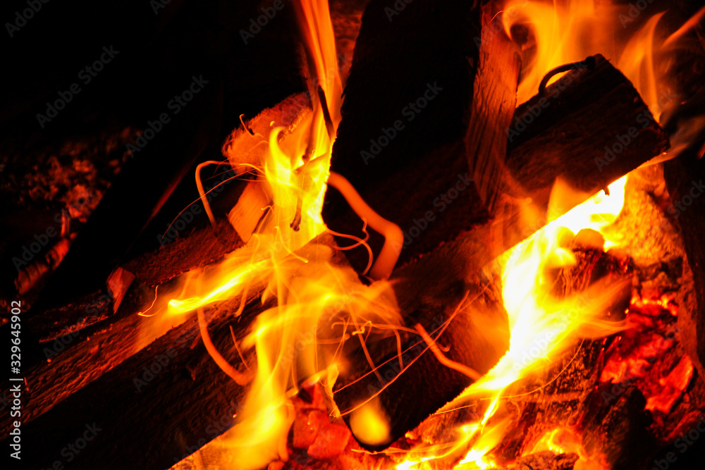 Macro shot of burning firewood with an open flame. Fire close Macro shot of burning firewood with an open flame. Fire close