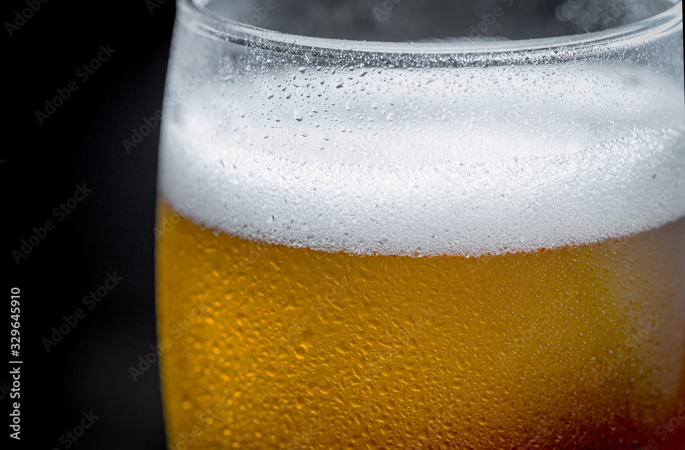 Light beer in a glass on a table in composition with accessories on an old background Light beer in a glass on a table in composition with accessories on an old background