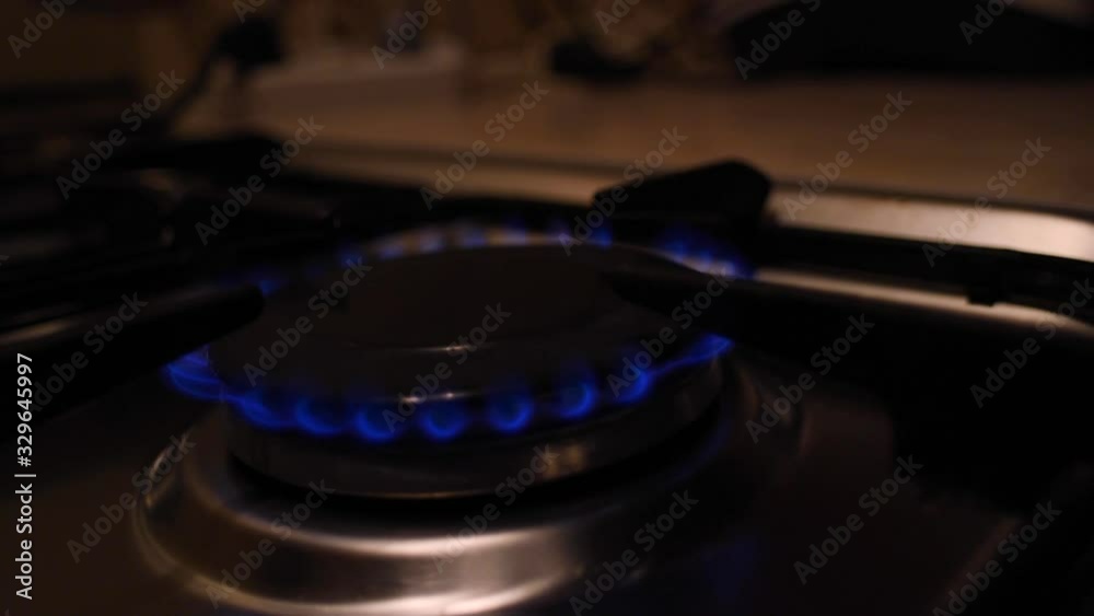 Movement around a burning gas stove. Side view. Movement around a burning gas stove. Side view.