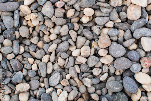 Sea pebbles. Background of pebbles. Wet stones. Multicolored pebbles. Sea shore.