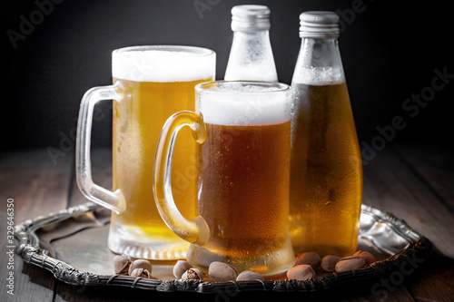 Light beer in a glass on a table in composition with accessories on an old background