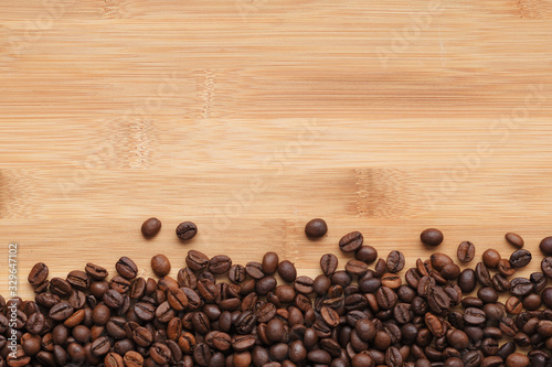 coffee beans on wooden background from above with copyspace