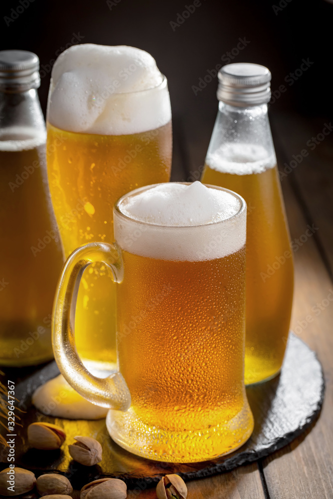Light beer in a glass, on an old background. Light beer in a glass, on an old background.