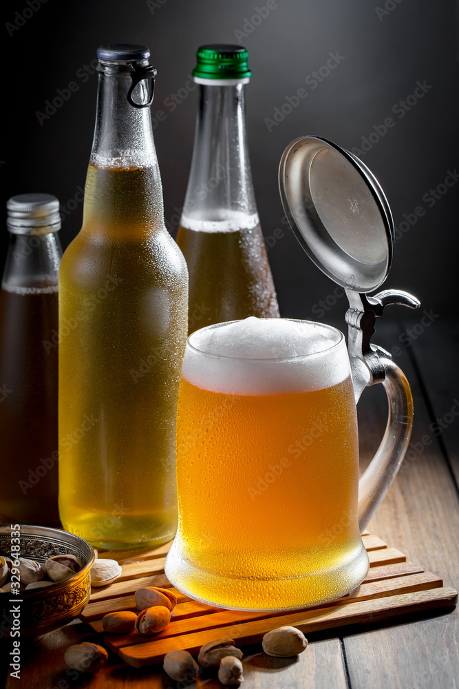 Light beer in a glass, on an old background. Light beer in a glass, on an old background.