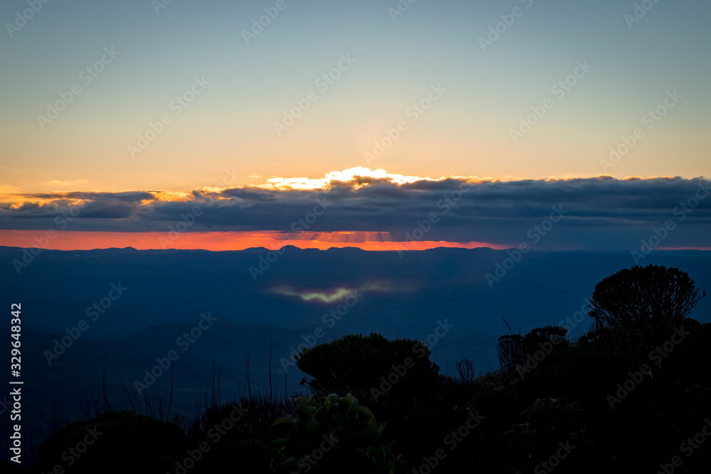Orange sunset on top of the mountain, Pico do Itambe, Minas Gerais, Brazil