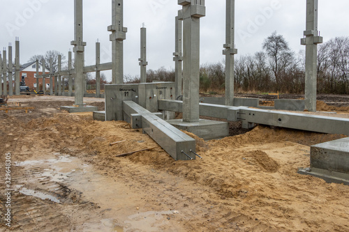 a large construction site many concrete columns are placed with the help of a crane