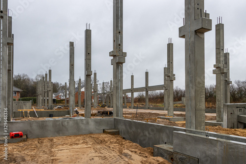 a large construction site many concrete columns are placed with the help of a crane