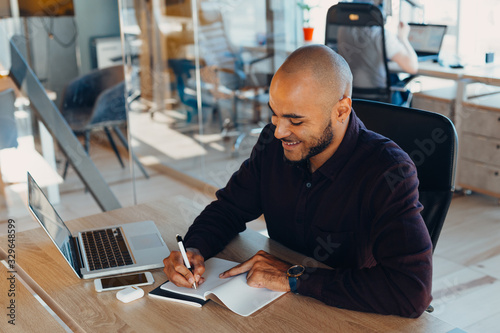 African american businessman sitting at a computer in his startup office