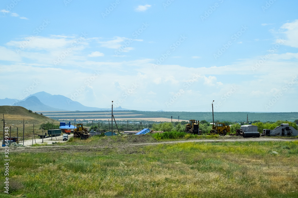 Old agricultural machinery stands in village on a site with agricultural machinery Old agricultural machinery stands in village on a site with agricultural machinery