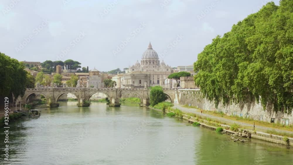 Panorama of famous european attraction The Papal Basilica of Saint Peter in Vatican city. Tiber river and St. Angelo bridge at cloudy day Panorama of famous european attraction The Papal Basilica of Saint Peter in Vatican city. Tiber river and St. Angelo bridge at cloudy day