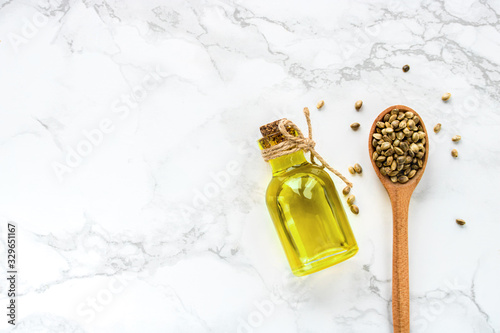 cannabis oil and hemp seeds on a white background. Flat lay.