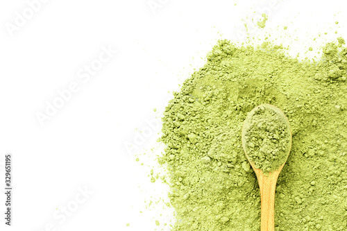 matcha tea green powder with a wooden spoon on a white background with place for text. Prescription antioxidant facial mask.