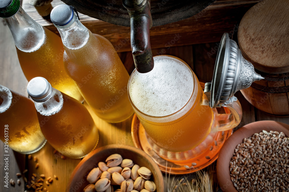 Light beer in a glass, on an old background. Light beer in a glass, on an old background.