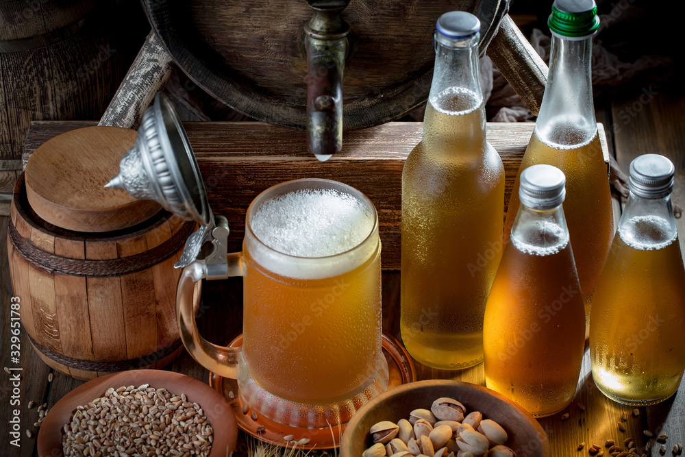 Light beer in a glass on a table in composition with accessories on an old background Light beer in a glass on a table in composition with accessories on an old background