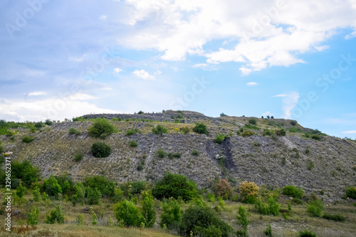 ore slag dumps after processing. Old stepped terricon in form of a hill with terraces