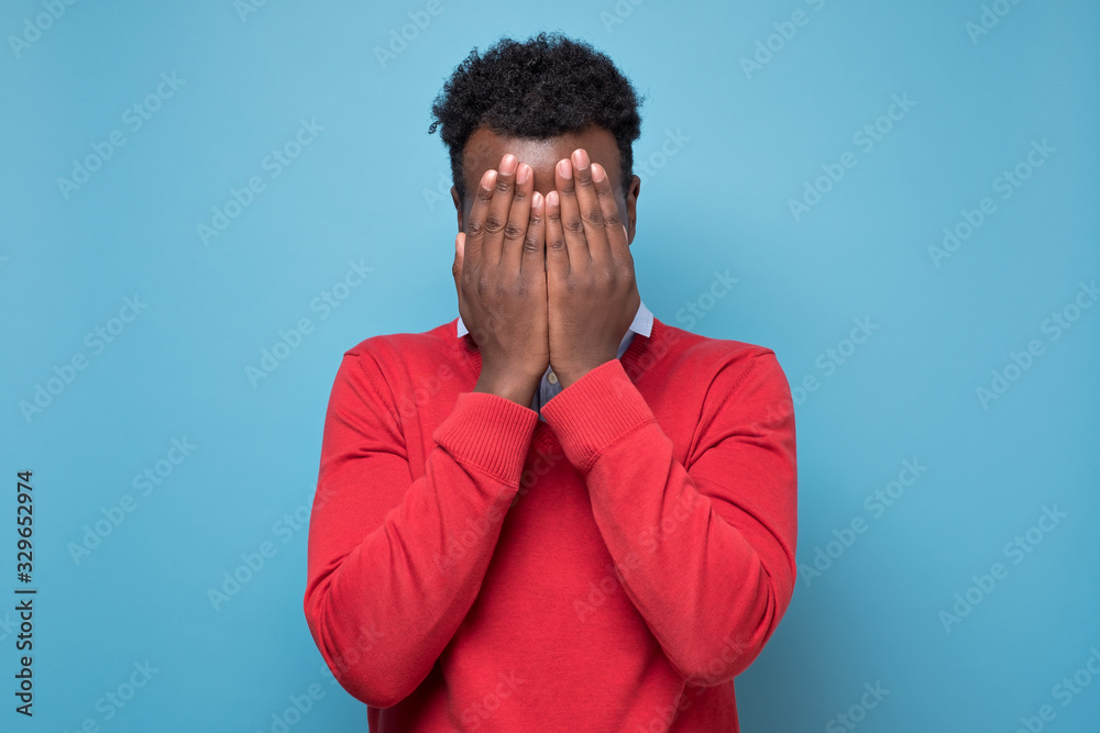 Φωτογραφία African american black man covering eyes being stressed trying to stay anonym