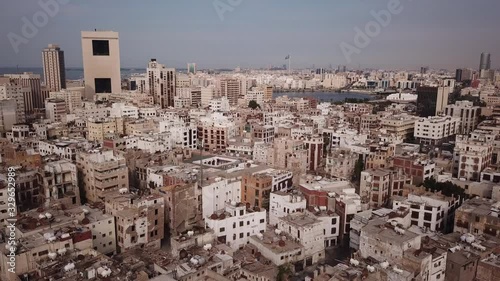 Retreating drone flight over Unesco World Heritage site of Al Balad with the skyline of Jeddah in the background, urban landscape Saudi Arabia photo