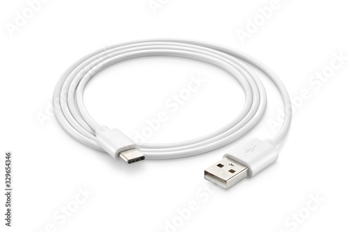 A white USB type C charger cable, compatible for many devices, wrapped in a spiral shape, isolated on white background. photo