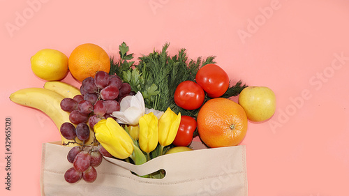 Fototapeta Naklejka Na Ścianę i Meble -  Healthy natural products in an eco bag on a bright background, the concept of a healthy lifestyle and weight loss, zero waste. Vegetables, fruits in tissue packaging, diet. Banner for the store. No pl