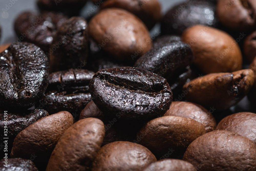 Macro view of natural and roasted coffee mix beans Macro view of natural and roasted coffee mix beans