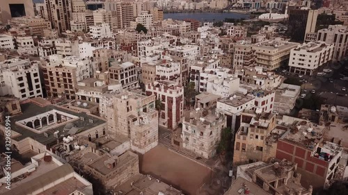 Tilted aerial view of traditional merchant houses made of coral limestone and carved wood, in historic Al Balad neighborhood, the old town of Jeddah, Saudi Arabia photo