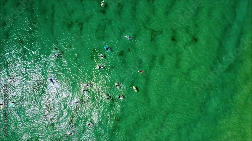 Spiral rocket shot of surfers in Australia. Drone shot of surfers great for spiral transition. photo
