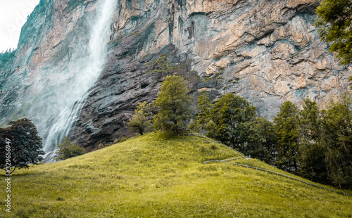 Small mountain waterfall. Summer alpine mountain landscape. Famous valley of waterfalls in Lauterbrunnen.