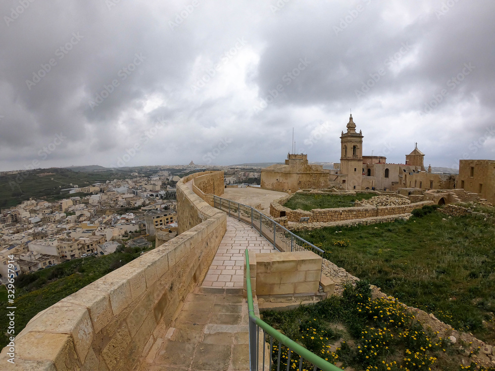 View from the stone bridge of the Victoria Citadel to Gozo Island in cloudy weather, Malta.