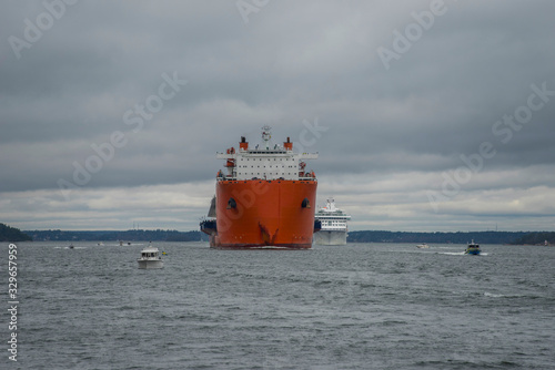 Ship transportation of a new bridge, Guldbron, from China to Stockholm in the archipelago passage Oxdjupet a gray day.