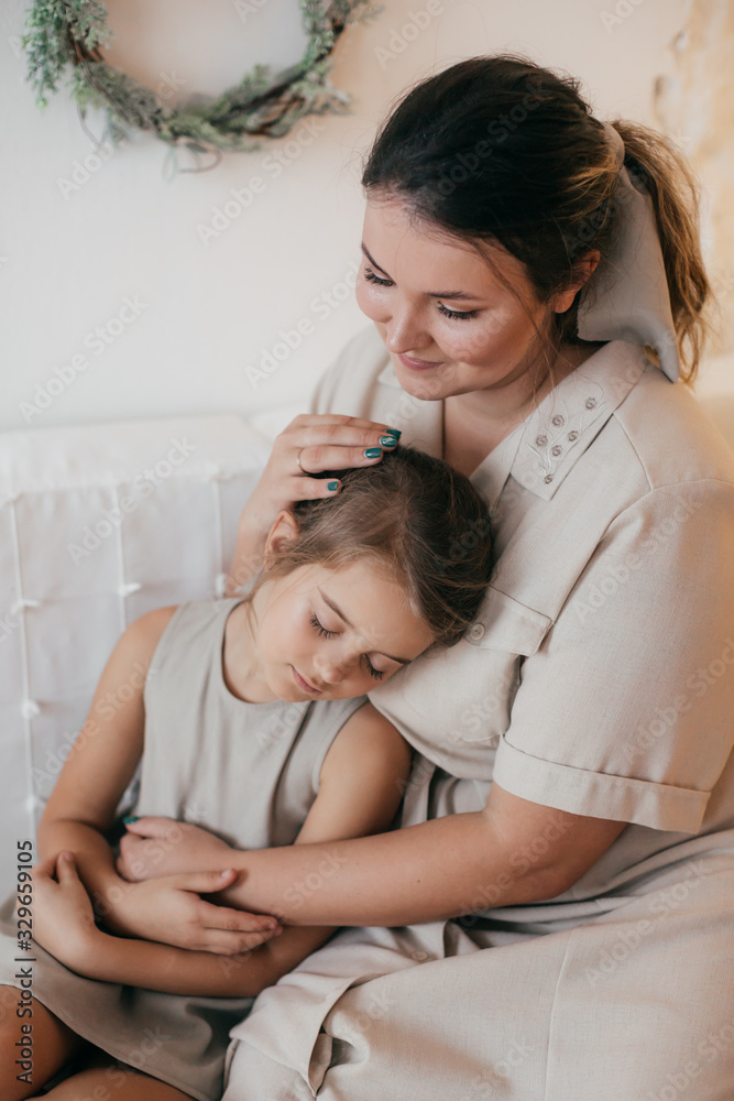 Baby girl and mother near Christmas tree