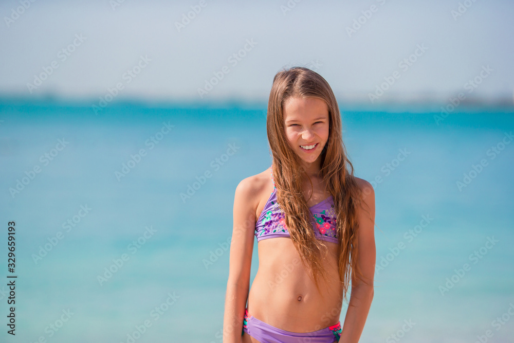 Adorable little girl have fun at tropical beach during vacation Adorable little girl have fun at tropical beach during vacation