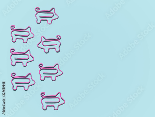 top view of group with pigs paper clips in one direction and one in different isolated on blue