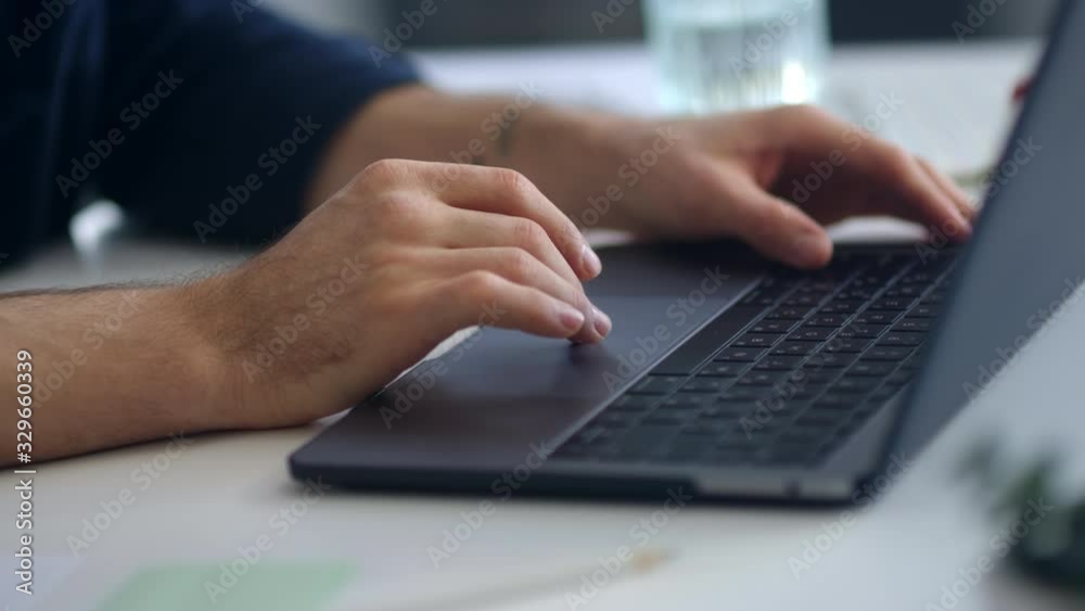 Close up man hands surfing internet on computer. Businessman hands typing laptop Close up man hands surfing internet on computer. Businessman hands typing laptop