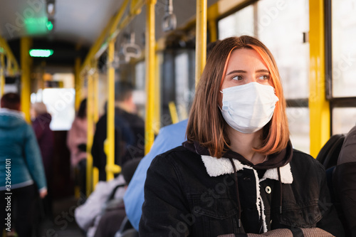 Young adult commutes in a protective face mask. Coronavirus, COVID-19 spread prevention concept, responsible social behaviour of a citizen