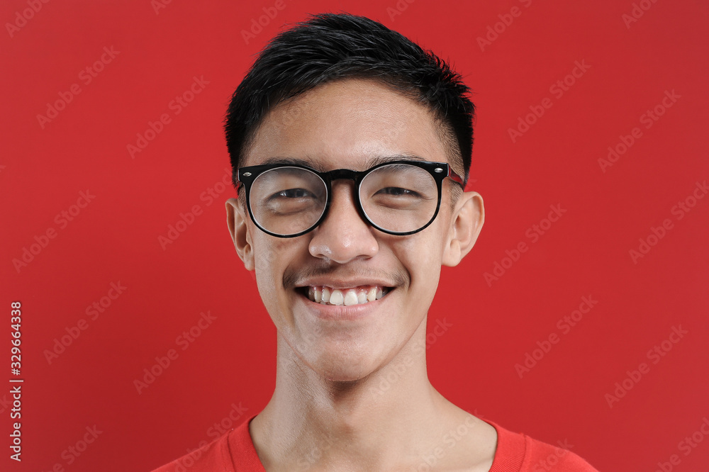 Happy smiling young Asian man with eyeglasses Happy smiling young Asian man with eyeglasses