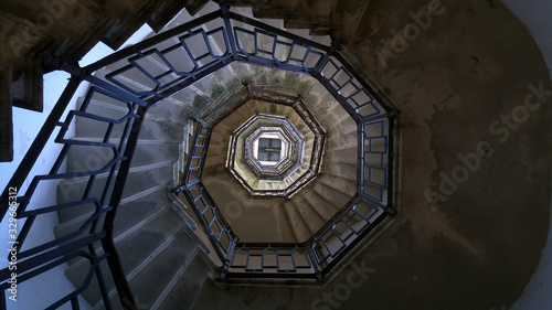 Staircase to the lighthouse on Lake Como in Italy. Spiral staircase up. Abstract background.