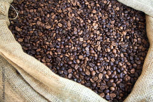 Big cloth bag filled of roasted coffee beans © ovbelov1972