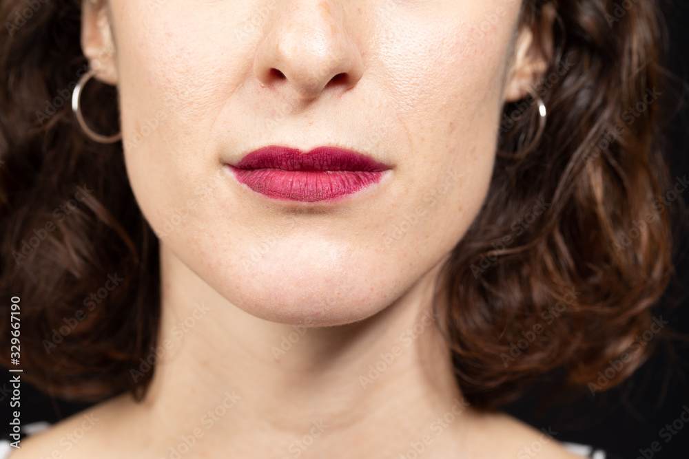 Beautiful brunette women face detail with sensual lips with red matt lipstick. Cosmetology, drugstore and fashion makeup concept... Beautiful brunette women face detail with sensual lips with red matt lipstick. Cosmetology, drugstore and fashion makeup concept...