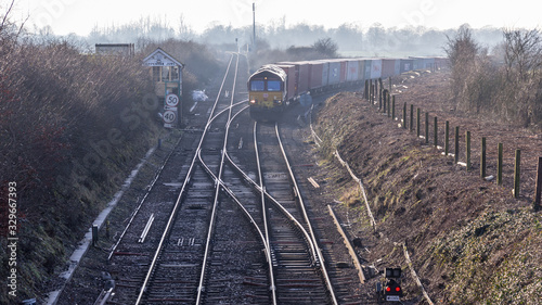 Freight train passing through the Suffolk countryside by Chippenham junction onwards to Felixstowe.