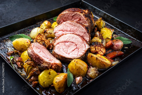 Cuadro en lienzo Traditional roasted veal roll roast offered with potatoes, carrots and onions as