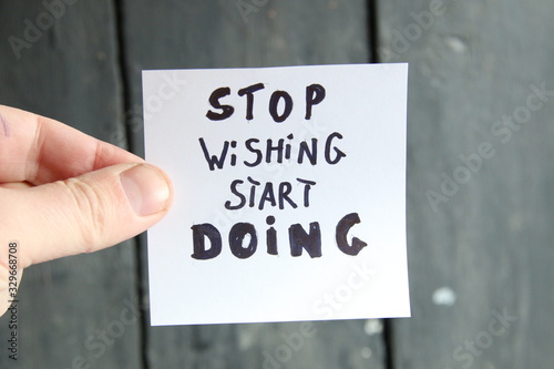 stop dreaming start doing, motivational inscription on a sheet of paper